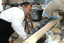 ならい旋盤という専用の機械で、丸い木材の形に削る